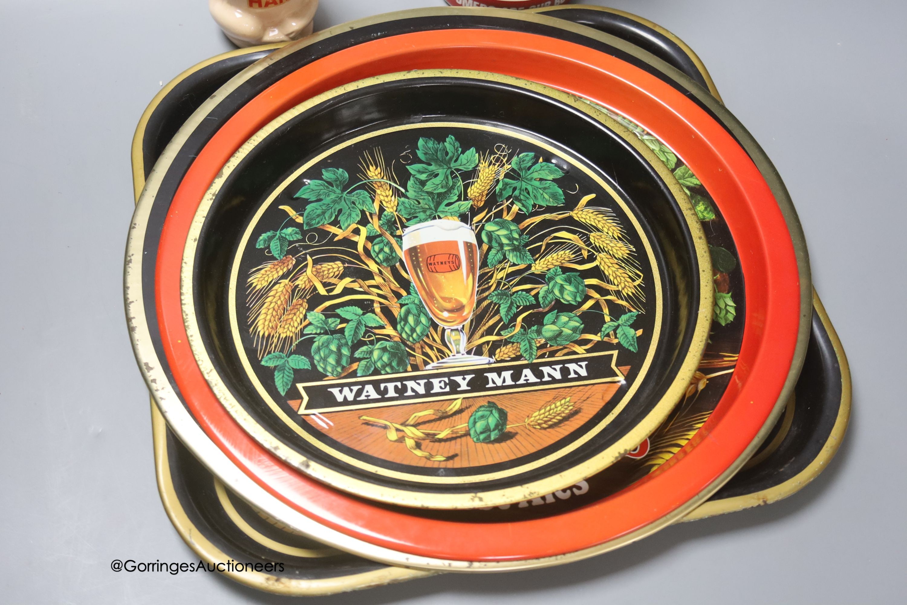 Three Watney's ale trays, a Batemans beer tray, a 'Harris' piggy bank and a Little Chef figure